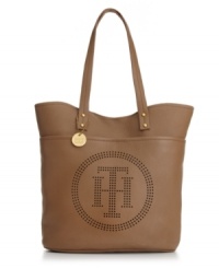 Keep your look classic with a monogram detailed tote from Tommy Hilfiger. A unique perforated front and polished gold-tone hardware add refined appeal to this travel-ready shape. Keep your look classic with a monogram detailed tote from Tommy Hilfiger. A unique perforated front and polished gold-tone hardware add refined appeal to this travel-ready shape.