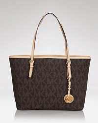 The essential MICHAEL Michael Kors tote captures the essence of easy glamour, finished by a tony buckle and trimmed in leather. Consider it a first class ticket. The essential MICHAEL Michael Kors tote captures the essence of easy glamour, finished by a tony buckle and trimmed in leather. Consider it a first class ticket.