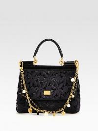 A truly feminine style that features pretty, cotton floral lace over shimmery sequins with patent leather trim and a detachable, embellished dual chain strap.Patent leather top handle, 3 dropDetachable embellished, dual chain shoulder strap, 8½ dropMagnetic snap flap closureOne inside open pocketSatin lining8W X 6¾H X 3½DMade in Italy A truly feminine style that features pretty, cotton floral lace over shimmery sequins with patent leather trim and a detachable, embellished dual chain strap.Patent leather top handle, 3 dropDetachable embellished, dual chain shoulder strap, 8½ dropMagnetic snap flap closureOne inside open pocketSatin lining8W X 6¾H X 3½DMade in Italy