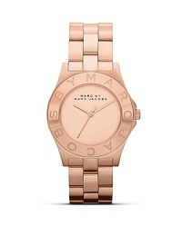 Perfect playful accessorizing with this watch from MARC BY MARC JACOBS. Crafted from rose gold plate with a logo-engraved bezel, this piece has style-setter written all over it. Perfect playful accessorizing with this watch from MARC BY MARC JACOBS. Crafted from rose gold plate with a logo-engraved bezel, this piece has style-setter written all over it.