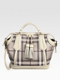 The iconic Burberry check defines this roomy shape of smooth PVC, finished with leather trim and super-chic tassels. Double leather top handles, 3¼ dropAdjustable detachable leather shoulder strap, 17-20½ dropTop zip closureOne inside zip pocketTwo inside open pocketsCotton lining13W X 12¾H X 7¾DMade in Italy The iconic Burberry check defines this roomy shape of smooth PVC, finished with leather trim and super-chic tassels. Double leather top handles, 3¼ dropAdjustable detachable leather shoulder strap, 17-20½ dropTop zip closureOne inside zip pocketTwo inside open pocketsCotton lining13W X 12¾H X 7¾DMade in Italy
