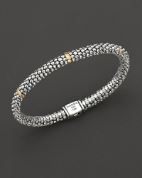 Sterling silver Caviar™ beaded oval rope bracelet with five gold stations with logo box clasp closure. Designed by Lagos. Sterling silver Caviar™ beaded oval rope bracelet with five gold stations with logo box clasp closure. Designed by Lagos.