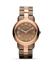 Coolly sized and big on shine. This plated metallic watch from MARC BY MARC JACOBS flaunts the brand's enviable aesthetic with everyday allure. Coolly sized and big on shine. This plated metallic watch from MARC BY MARC JACOBS flaunts the brand's enviable aesthetic with everyday allure.