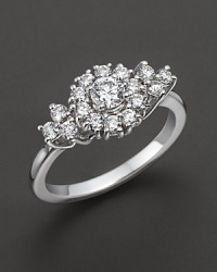 White gold diamond flower cluster ring. With signature ruby accent. Designed by Roberto Coin. White gold diamond flower cluster ring. With signature ruby accent. Designed by Roberto Coin.