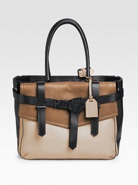 A unique leather carryall in a trio of colors, features a spacious design with a modern attitude.Double top handles, 8 drop One outside flap pocket One outside snap pocket Protective metal feet One inside zip pocket Two inside open pockets Center zip compartment Two center compartments Cotton lining 14W X 10½H X 6½D Imported A unique leather carryall in a trio of colors, features a spacious design with a modern attitude.Double top handles, 8 drop One outside flap pocket One outside snap pocket Protective metal feet One inside zip pocket Two inside open pockets Center zip compartment Two center compartments Cotton lining 14W X 10½H X 6½D Imported