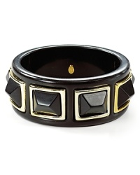 Pyramids etched in 22-karat gold tone dress up this resin bangle from Kenneth Jay Lane, crafted for a hit of mod-meets-modern cool. Pyramids etched in 22-karat gold tone dress up this resin bangle from Kenneth Jay Lane, crafted for a hit of mod-meets-modern cool.