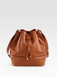 This luxurious pebbled leather design has a sophisticated, yet sporty aesthetic.Adjustable shoulder strap, 18½-20½ dropDrawstring closureOne inside zip pocketTwo inside open pocketsOne mirrorCanvas lining10½W X 11H X 7DImported This luxurious pebbled leather design has a sophisticated, yet sporty aesthetic.Adjustable shoulder strap, 18½-20½ dropDrawstring closureOne inside zip pocketTwo inside open pocketsOne mirrorCanvas lining10½W X 11H X 7DImported
