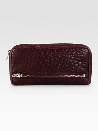 Beautifully pebbled leather with edgy zipper details.Zip-around closureTwo outside zip pocketThree bill compartmentsTwelve credit card slotsFully lined8¼W X 4½H X 1DImported Beautifully pebbled leather with edgy zipper details.Zip-around closureTwo outside zip pocketThree bill compartmentsTwelve credit card slotsFully lined8¼W X 4½H X 1DImported