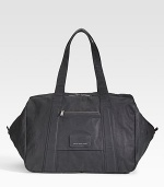 An oversized carryall ideal for a daytrip or an overnight jaunt, constructed in coated canvas and destined to last for years to come. Zip closure Covered logo plate Exterior zip pocket Interior slip pocket Fully lined 19¾W X 12H X 12D Imported 