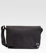 A rugged, everyday look crafted in lasting denier canvas with a convenient laptop compartment. Grip tape closure Exterior zip pocket Interior zip and organizing pockets Laptop compartment Adjustable shoulder strap 18W X 11½H X 5½D Imported 