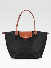 Lightweight nylon signature tote, great for travel as well as everyday use. Top zip plus leather snap flap and shoulder strapsFolds up and snaps closedInside pocketOpens to a 12¼W X 11¾H X 7½D toteImportedFOR PERSONALIZATION Select a quantity, then scroll down and click on PERSONALIZE & ADD TO BAG to choose and preview your personalization options. Please allow 1 week for delivery. Lightweight nylon signature tote, great for travel as well as everyday use. Top zip plus leather snap flap and shoulder strapsFolds up and snaps closedInside pocketOpens to a 12¼W X 11¾H X 7½D toteImportedFOR PERSONALIZATION Select a quantity, then scroll down and click on PERSONALIZE & ADD TO BAG to choose and preview your personalization options. Please allow 1 week for delivery.