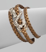 From the Naga Collection. A braid of rich leather wraps the wrist three times while weaving in and out of a curvaceous silver dragon.LeatherSterling silverLength, about 6½Lobster claspMade in Bali