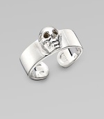 A thick adjustable band with a single prominent skull at the center. Sterling silver Width, about ¾ Made in Italy 