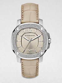 An dazzling timepiece with a diamond bezel on a brushed, grey stainless steel case and a luxurious alligator strap. Quartz movementWater resistant to 5 ATMOctagonal stainless steel case, 38mm (1.5) Diamond and screw accented bezel, 00 tcwNude dialBar and numeric hour markersSecond hand Trench alligator strapMade in Switzerland An dazzling timepiece with a diamond bezel on a brushed, grey stainless steel case and a luxurious alligator strap. Quartz movementWater resistant to 5 ATMOctagonal stainless steel case, 38mm (1.5) Diamond and screw accented bezel, 00 tcwNude dialBar and numeric hour markersSecond hand Trench alligator strapMade in Switzerland