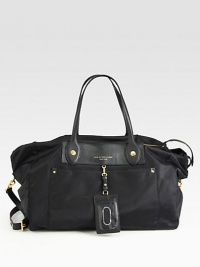 Lightweight nylon and luxurious leather come together in the perfect travel style.Double leather top handles, 8½ dropDetachable adjustable leather shoulder strap, 22-24 dropTop zip closureTwo outside open pocketsOne inside zip pocketTwo inside open pocketsFully lined11½W X 13H X 8DImported Lightweight nylon and luxurious leather come together in the perfect travel style.Double leather top handles, 8½ dropDetachable adjustable leather shoulder strap, 22-24 dropTop zip closureTwo outside open pocketsOne inside zip pocketTwo inside open pocketsFully lined11½W X 13H X 8DImported