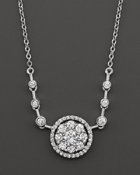 Diamond flower cluster pendant with bezel stations on the chain. Set in 14 Kt. white gold. Diamond flower cluster pendant with bezel stations on the chain. Set in 14 Kt. white gold.