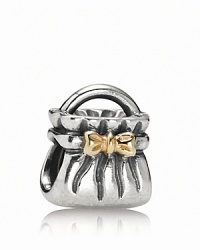 A 14K gold bow adds glamour to PANDORA's sterling silver purse charm. A 14K gold bow adds glamour to PANDORA's sterling silver purse charm.