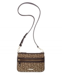 Signature jacquard distinguishes the crossbody purse by Calvin Klein. Remove the strap to carry it as a clutch. Signature jacquard distinguishes the crossbody purse by Calvin Klein. Remove the strap to carry it as a clutch.