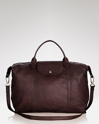 Longchamp updates its much-adored Le Pliage tote in luxurious leather while maintaining the effortless practicality that has made the brand's carryall a season-to-season favorite. Longchamp updates its much-adored Le Pliage tote in luxurious leather while maintaining the effortless practicality that has made the brand's carryall a season-to-season favorite.