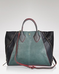 Masculine influences inform this leather Pour La Victoire tote, which flaunts a subtle structure and spacious silhouette. Practical side zippers detail the exterior, while a simple snap closure secures the top. Masculine influences inform this leather Pour La Victoire tote, which flaunts a subtle structure and spacious silhouette. Practical side zippers detail the exterior, while a simple snap closure secures the top.