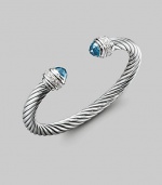 From the Silver Ice Collection. A bold twisted cable of sterling silver, capped with faceted blue topaz and banded with pavé diamonds. Diamonds, 0.48 tcw Blue topaz Sterling silver Cable, 7mm Diameter, about 2¼ Made in USA