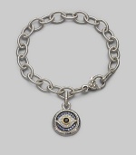 Bold, textured links of sterling silver hold a protective evil eye charm, radiantly created of white, blue and black sapphires with a touch of 18k gold. Sapphires Sterling silver and 18k yellow gold Bracelet length, about 7½ Charm diameter, about ¾ Heart-shaped lobster clasp Made in USA