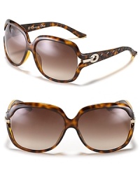 Chic oversized sunglasses with open temples and circular metal detail along arms. Chic oversized sunglasses with open temples and circular metal detail along arms.