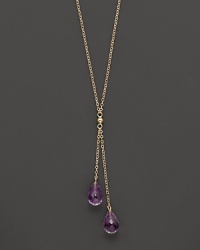 Twin amethyst briolettes sparkle from this 14K yellow gold lariat necklace. Twin amethyst briolettes sparkle from this 14K yellow gold lariat necklace.