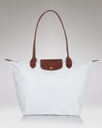 A timeless nod to French style, Longchamp's nylon tote perfects carryall style. This roomy and packable bag is prime for the chic girl, whether she's in-town or overseas. A timeless nod to French style, Longchamp's nylon tote perfects carryall style. This roomy and packable bag is prime for the chic girl, whether she's in-town or overseas.