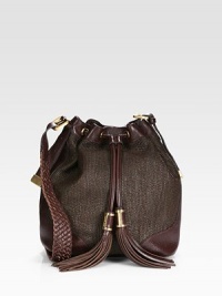Woven raffia pairs with rich leather in this cinched carryall, finished with pull tassels and a chic braided strap.Adjustable shoulder strap, 19¾-24 dropDrawstring and magnetic top closureOne outside zip pocketProtective metal feetOne inside zip pocketFully lined10½W X 12H X 7DImported Woven raffia pairs with rich leather in this cinched carryall, finished with pull tassels and a chic braided strap.Adjustable shoulder strap, 19¾-24 dropDrawstring and magnetic top closureOne outside zip pocketProtective metal feetOne inside zip pocketFully lined10½W X 12H X 7DImported