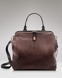 A voluminous Furla leather satchel shines with an elongated, yet polished silhouette. Handles and a detachable strap detail the exterior, and the zip top opens to an interior with multiple pockets. A voluminous Furla leather satchel shines with an elongated, yet polished silhouette. Handles and a detachable strap detail the exterior, and the zip top opens to an interior with multiple pockets.