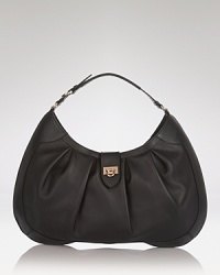 Salvatore Ferragamo's leather hobo boasts the label's signature polish. Ideal with daytime looks, this go-anywhere bag is oh so chic with both dresses and jeans. Salvatore Ferragamo's leather hobo boasts the label's signature polish. Ideal with daytime looks, this go-anywhere bag is oh so chic with both dresses and jeans.