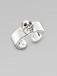 A thick adjustable band with a single prominent skull at the center. Sterling silver Width, about ¾ Made in Italy A thick adjustable band with a single prominent skull at the center. Sterling silver Width, about ¾ Made in Italy