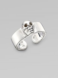 A thick adjustable band with a single prominent skull at the center. Sterling silver Width, about ¾ Made in Italy 