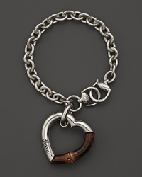 Sterling silver and bamboo heart charm bracelet by Gucci. Sterling silver and bamboo heart charm bracelet by Gucci.