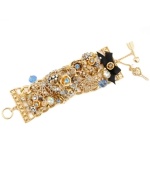 Start a conversation in this not-so-subtle style. Betsey Johnson's sparkling toggle bracelet combines detailed heart and flower charms combined with clear and blue crystal accents and a black grosgrain ribbon detail. Set in gold-plated mixed metal. Approximate length: 7-1/2 inches.
