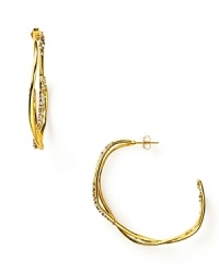 Scattered with glittering Swarovski crystals, the orbiting rings of these 18 Kt. rose gold plated earrings give an impression of mesmerizing movement. By Alexis Bittar. Scattered with glittering Swarovski crystals, the orbiting rings of these 18 Kt. rose gold plated earrings give an impression of mesmerizing movement. By Alexis Bittar.