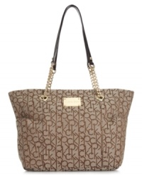 Trimmed with soft leather, this elegant design from Calvin Klein features signature jacquard with golden detailing. The practical interior, with plenty of pockets, makes it an exquisitely organized option. Trimmed with soft leather, this elegant design from Calvin Klein features signature jacquard with golden detailing. The practical interior, with plenty of pockets, makes it an exquisitely organized option.