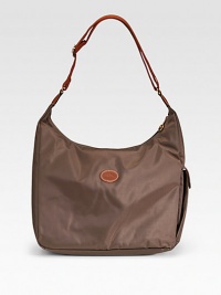 Chic leather-trimmed canvas duffle with a side cell phone pocket has a water-resistant lining, making it perfect for the beach - and beyond.Adjustable shoulder strap, 15-20 drop Zip top closure Outside end flap pocket Inner zip and open pockets Fully lined 14½W X 11H X 5½D Imported Chic leather-trimmed canvas duffle with a side cell phone pocket has a water-resistant lining, making it perfect for the beach - and beyond.Adjustable shoulder strap, 15-20 drop Zip top closure Outside end flap pocket Inner zip and open pockets Fully lined 14½W X 11H X 5½D Imported