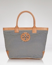 Tory Burch channels French chic with this roomy striped tote. Designed to be your new go-everywhere carryall in sturdy canvas with leather trims, it's sure to be the bag your reach for again and again. Tory Burch channels French chic with this roomy striped tote. Designed to be your new go-everywhere carryall in sturdy canvas with leather trims, it's sure to be the bag your reach for again and again.