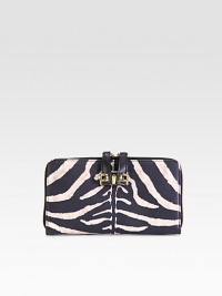 Luxurious zebra-print leather with radiant hardware and secured zipper pulls.Two-way zip-around closureSecured zipper pullsOne inside zip pocketTwo open compartmentsTwelve credit card slotsTwo bill compartmentsFully lined7½W X 4¼H X 1DMade in Italy Luxurious zebra-print leather with radiant hardware and secured zipper pulls.Two-way zip-around closureSecured zipper pullsOne inside zip pocketTwo open compartmentsTwelve credit card slotsTwo bill compartmentsFully lined7½W X 4¼H X 1DMade in Italy