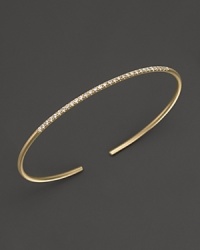A simply modern diamond bangle in 14K yellow gold from Meira T. A simply modern diamond bangle in 14K yellow gold from Meira T.