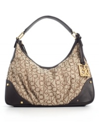 Calvin Klein wraps the popular hobo silhouette in a modern logo jacquard for a stylish everyday purse. Calvin Klein wraps the popular hobo silhouette in a modern logo jacquard for a stylish everyday purse.