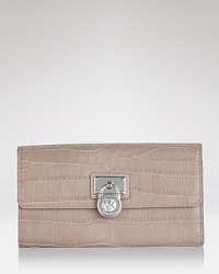A logo-stamped lock detail toughens up this sleek crocodile-embossed leather wallet. By MICHAEL Michael Kors. A logo-stamped lock detail toughens up this sleek crocodile-embossed leather wallet. By MICHAEL Michael Kors.