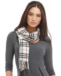 Luxuriously soft cashmere scarf in an all over check pattern is finished with fringe trim. Luxuriously soft cashmere scarf in an all over check pattern is finished with fringe trim.