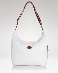 Longchamp's nylon hobo is a fuss-free take on a classic shape. Carry the pretty-practical style to add an enviable dose of Parisian chic to everyday looks. Longchamp's nylon hobo is a fuss-free take on a classic shape. Carry the pretty-practical style to add an enviable dose of Parisian chic to everyday looks.