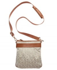This signature Calvin Klein crossbody has a casual downtown vibe, great for the weekend. An easy top zip closure and classic leather trim top off this easy going around-town style. This signature Calvin Klein crossbody has a casual downtown vibe, great for the weekend. An easy top zip closure and classic leather trim top off this easy going around-town style.