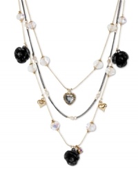 Love with a dark side. Betsey Johnson's illusion necklace features three layers of black glitter roses, crystal hearts, clear faceted beads, gold tone bubble hearts, small glass pearls and black tone chains. Crafted in antiqued gold tone mixed metal. Approximate length: 16 inches + 3-inch extender. Approximate drop: 3-1/2 inches. Love with a dark side. Betsey Johnson's illusion necklace features three layers of black glitter roses, crystal hearts, clear faceted beads, gold tone bubble hearts, small glass pearls and black tone chains. Crafted in antiqued gold tone mixed metal. Approximate length: 16 inches + 3-inch extender. Approximate drop: 3-1/2 inches.