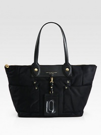 A structured, utilitarian-inflected shape in durable nylon, with wide exterior pockets and rich leather accents. Double leather top handles, 8½ dropTop zip closureThree outside open pocketsOne inside zip pocketTwo inside open pocketsFully lined12W X 11H X 5½DImported A structured, utilitarian-inflected shape in durable nylon, with wide exterior pockets and rich leather accents. Double leather top handles, 8½ dropTop zip closureThree outside open pocketsOne inside zip pocketTwo inside open pocketsFully lined12W X 11H X 5½DImported