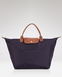 Take Longchamp's easy-chic style with you on your next vacation. Crafted of durable nylon with rich leather trims, this tote is on board with effortless daytime style. Take Longchamp's easy-chic style with you on your next vacation. Crafted of durable nylon with rich leather trims, this tote is on board with effortless daytime style.